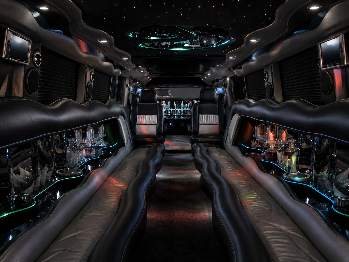 Dual axle H2 Hummer limousine interior with lounge seating and bar